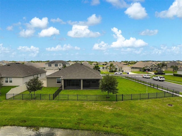 1817 Westerham Ave, Saint Cloud, FL 34771 - rear view of house featuring a residential view, a sunroom, a fenced backyard, and a shingled roof