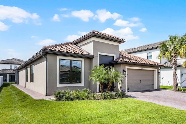 2000 Goblet Cove St, Kissimmee, FL 34746 - mediterranean / spanish home with a garage, driveway, stucco siding, and a front yard