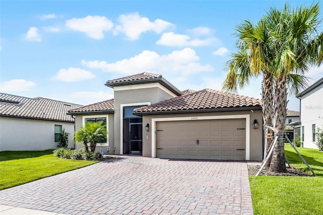 2000 Goblet Cove St, Kissimmee, FL 34746 - mediterranean / spanish home with an attached garage, decorative driveway, stucco siding, and a front lawn