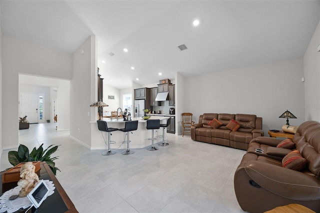 2000 Goblet Cove St, Kissimmee, FL 34746 - living area with lofted ceiling, recessed lighting, and light tile patterned flooring