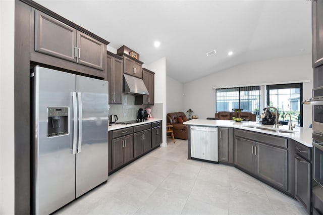 2000 Goblet Cove St, Kissimmee, FL 34746 - kitchen featuring stainless steel appliances, lofted ceiling, light countertops, dark brown cabinetry, and backsplash