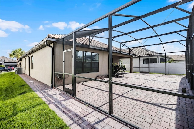 2000 Goblet Cove St, Kissimmee, FL 34746 - rear view of house featuring stucco siding, a lanai, a patio area, and a tiled roof