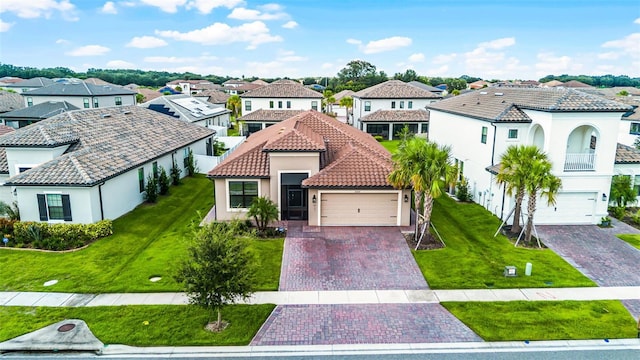 2000 Goblet Cove St, Kissimmee, FL 34746 - mediterranean / spanish home with a residential view, a tile roof, decorative driveway, stucco siding, and a front yard