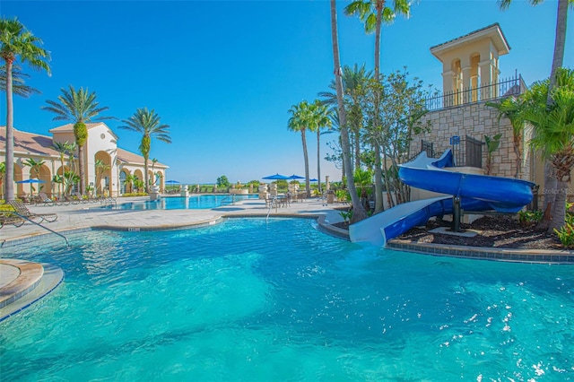 2000 Goblet Cove St, Kissimmee, FL 34746 - community pool with a water slide and a patio