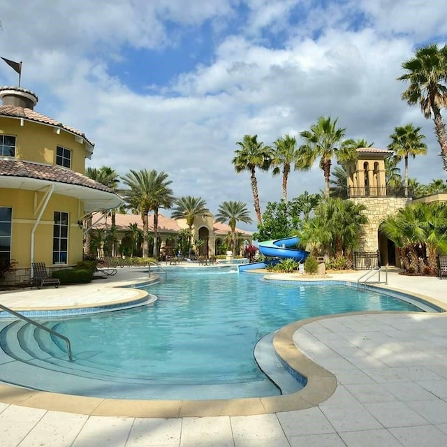 2000 Goblet Cove St, Kissimmee, FL 34746 - community pool with a water slide and a patio area