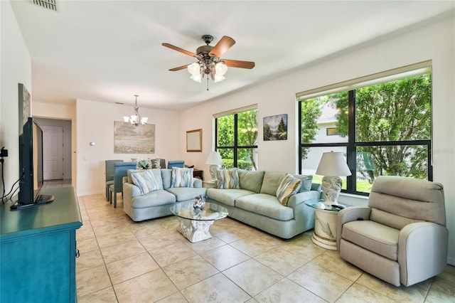 3390 Fallbrook Dr, Kissimmee, FL 34759 - living room with a chandelier, ceiling fan, and light tile patterned flooring