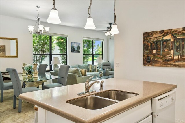 3390 Fallbrook Dr, Kissimmee, FL 34759 - kitchen featuring white dishwasher, a chandelier, white cabinets, and pendant lighting