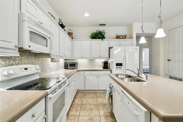 3390 Fallbrook Dr, Kissimmee, FL 34759 - kitchen with white appliances, white cabinetry, tasteful backsplash, and an island with sink