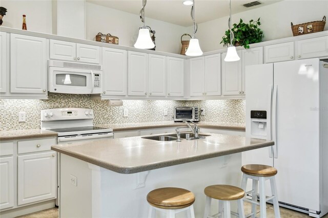 3390 Fallbrook Dr, Kissimmee, FL 34759 - kitchen featuring white appliances, decorative backsplash, white cabinets, and light countertops