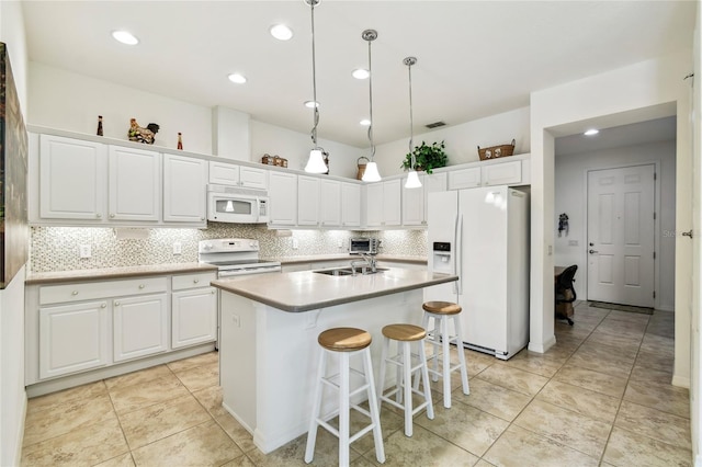 3390 Fallbrook Dr, Kissimmee, FL 34759 - kitchen with white appliances, white cabinets, decorative backsplash, a kitchen island with sink, and light countertops