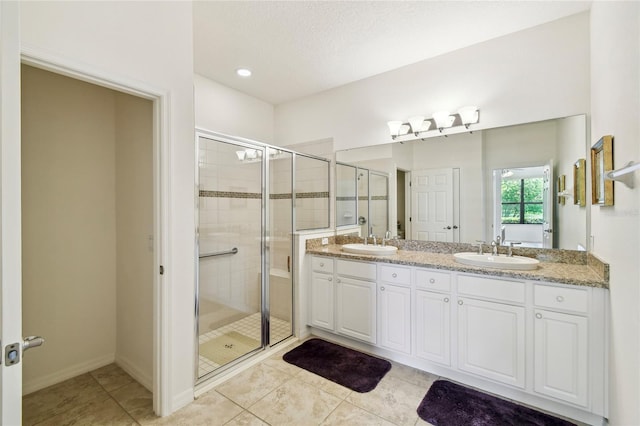 3390 Fallbrook Dr, Kissimmee, FL 34759 - bathroom with double vanity, a shower stall, and tile patterned floors