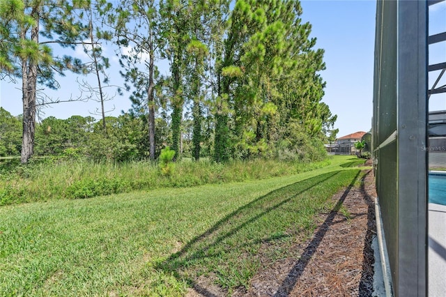 143 Tiger Lily Ct, Davenport, FL 33837 - view of green lawn featuring glass enclosure