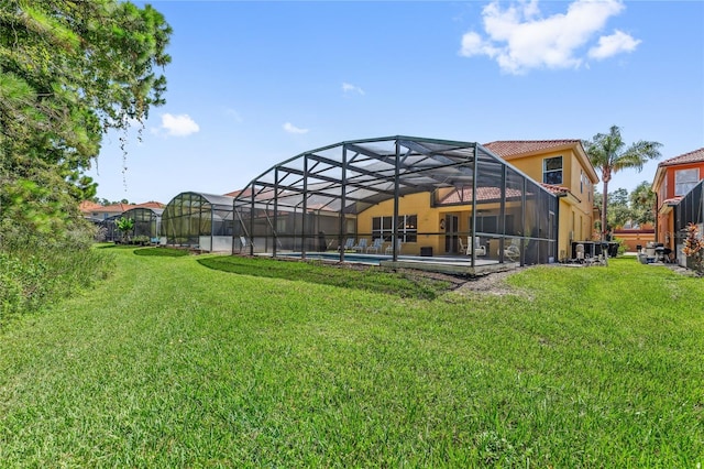 143 Tiger Lily Ct, Davenport, FL 33837 - view of green lawn with an outdoor pool, a patio area, and a lanai
