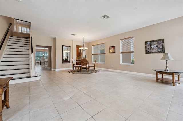 143 Tiger Lily Ct, Davenport, FL 33837 - living room with light tile patterned flooring, a chandelier, and stairway