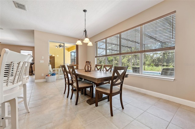 143 Tiger Lily Ct, Davenport, FL 33837 - dining space featuring light tile patterned floors, a textured ceiling, and a ceiling fan
