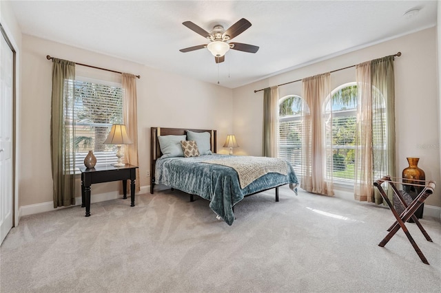 143 Tiger Lily Ct, Davenport, FL 33837 - bedroom featuring multiple windows, carpet, and a ceiling fan