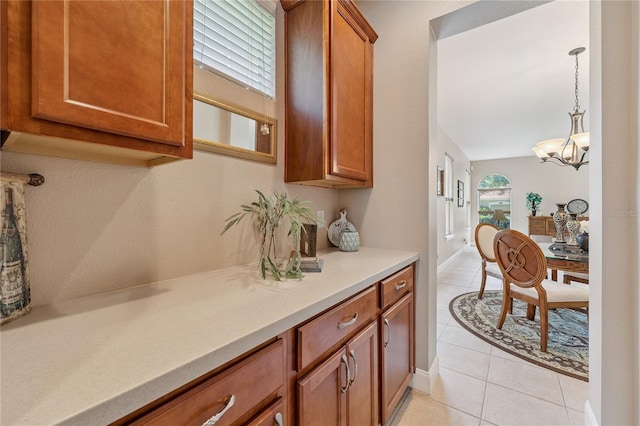 143 Tiger Lily Ct, Davenport, FL 33837 - bar area with light tile patterned floors, decorative light fixtures, and a chandelier