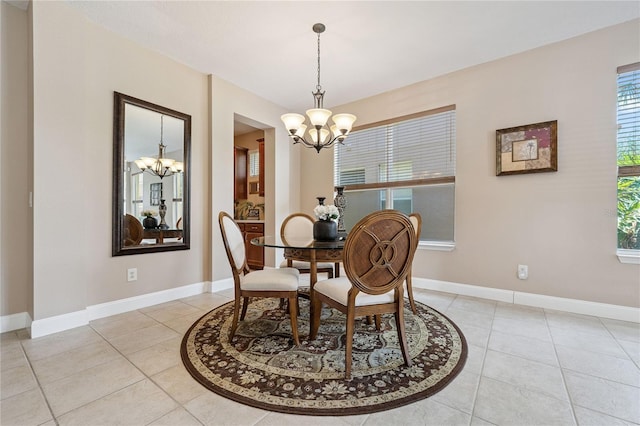143 Tiger Lily Ct, Davenport, FL 33837 - dining room featuring a chandelier and light tile patterned floors