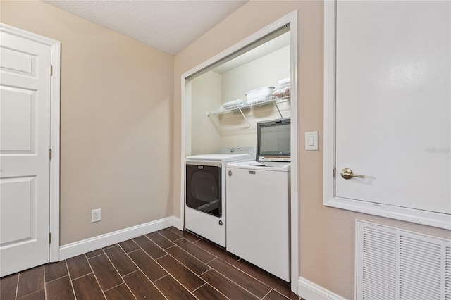 143 Tiger Lily Ct, Davenport, FL 33837 - laundry area featuring independent washer and dryer and wood finish floors