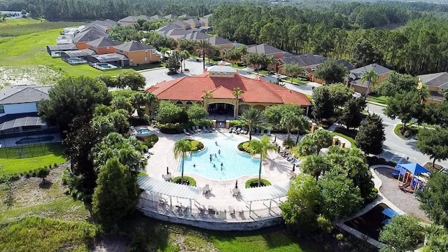 143 Tiger Lily Ct, Davenport, FL 33837 - aerial view of residential area featuring a pool and a heavily wooded area