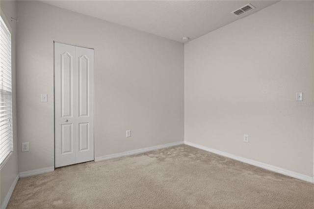 555 Lucerne Blvd, Winter Haven, FL 33881 - empty room featuring carpet floors and healthy amount of natural light