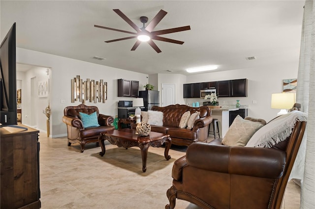 555 Lucerne Blvd, Winter Haven, FL 33881 - living area with a ceiling fan and light tile patterned floors