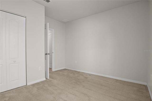 555 Lucerne Blvd, Winter Haven, FL 33881 - unfurnished bedroom featuring light colored carpet and a closet