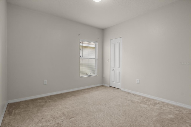 555 Lucerne Blvd, Winter Haven, FL 33881 - spare room featuring light carpet and baseboards