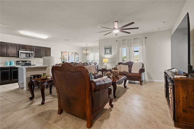 555 Lucerne Blvd, Winter Haven, FL 33881 - living room with ceiling fan, a chandelier, and light tile patterned flooring