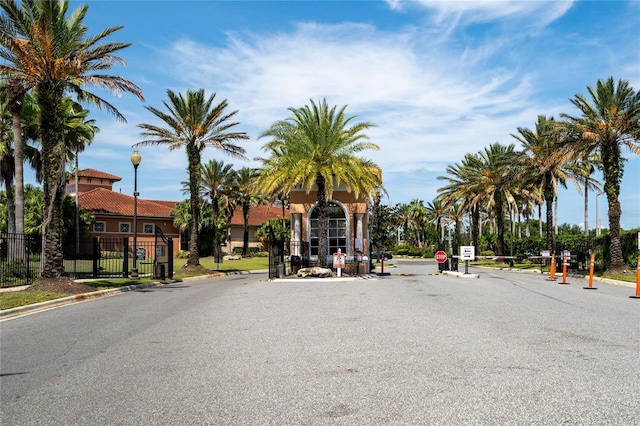 5548 Metrowest Blvd Unit 202, Orlando, FL 32811 - view of asphalt street with curbs, traffic signs, street lighting, and a gated entry