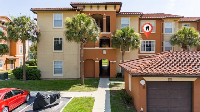 5548 Metrowest Blvd Unit 202, Orlando, FL 32811 - view of front of house featuring a tiled roof and stucco siding