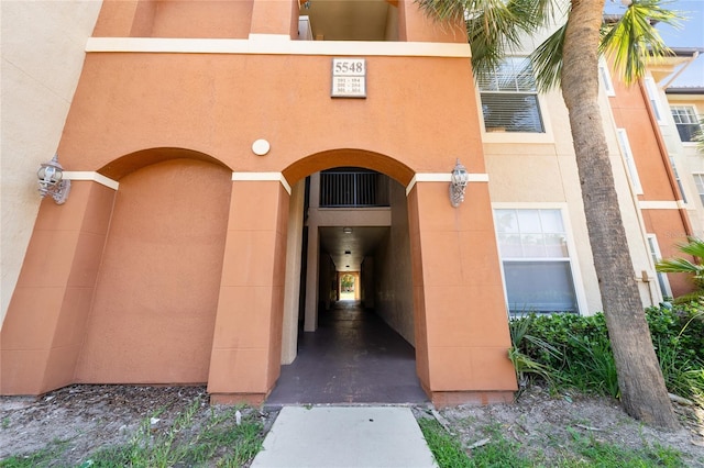 5548 Metrowest Blvd Unit 202, Orlando, FL 32811 - property entrance with stucco siding