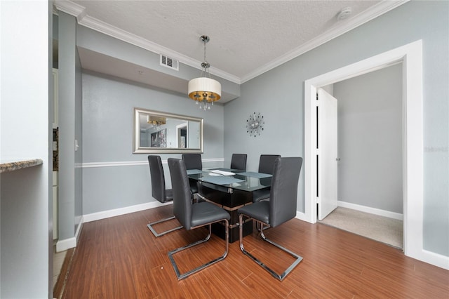 5548 Metrowest Blvd Unit 202, Orlando, FL 32811 - dining space with wood finished floors, ornamental molding, and a textured ceiling