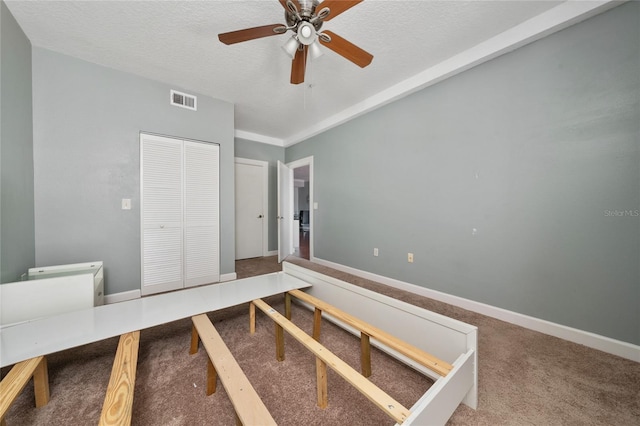 5548 Metrowest Blvd Unit 202, Orlando, FL 32811 - unfurnished bedroom featuring carpet, an office area, a textured ceiling, a closet, and ceiling fan