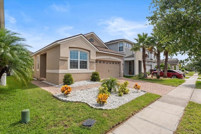 2511 Nouveau Way, Kissimmee, FL 34741 - view of front of home featuring stucco siding, decorative driveway, and a front lawn