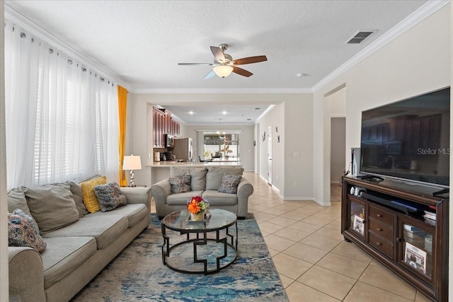 2511 Nouveau Way, Kissimmee, FL 34741 - living area featuring light tile patterned floors, ceiling fan, ornamental molding, and a textured ceiling