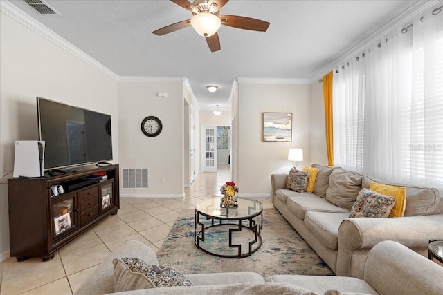2511 Nouveau Way, Kissimmee, FL 34741 - living area with light tile patterned floors, a ceiling fan, a textured ceiling, and crown molding