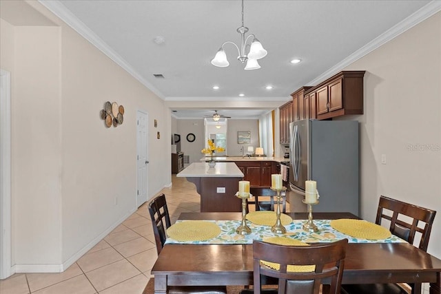 2511 Nouveau Way, Kissimmee, FL 34741 - dining space featuring light tile patterned flooring, ornamental molding, recessed lighting, a chandelier, and a ceiling fan