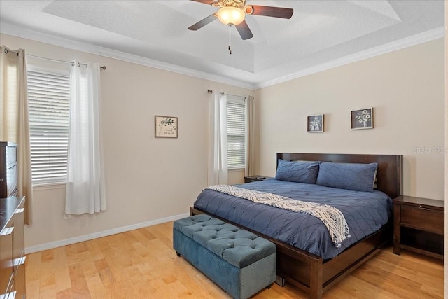 2511 Nouveau Way, Kissimmee, FL 34741 - bedroom featuring light wood-style flooring, a raised ceiling, ornamental molding, and a ceiling fan