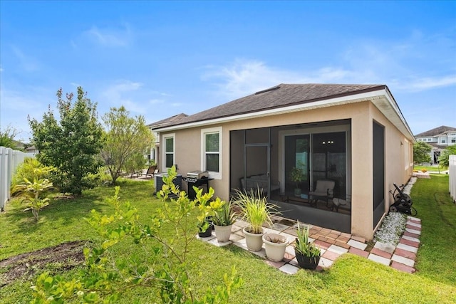 2511 Nouveau Way, Kissimmee, FL 34741 - rear view of property featuring stucco siding, a shingled roof, a sunroom, and a patio