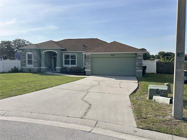 6003 Live Oak Dr, Winter Haven, FL 33880 - view of front of property featuring concrete driveway, an attached garage, stone siding, and roof with shingles