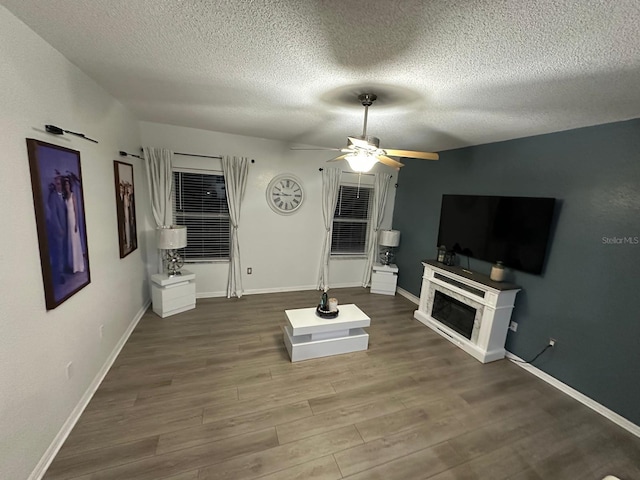 6003 Live Oak Dr, Winter Haven, FL 33880 - living area with ceiling fan, wood finished floors, a textured ceiling, and a fireplace