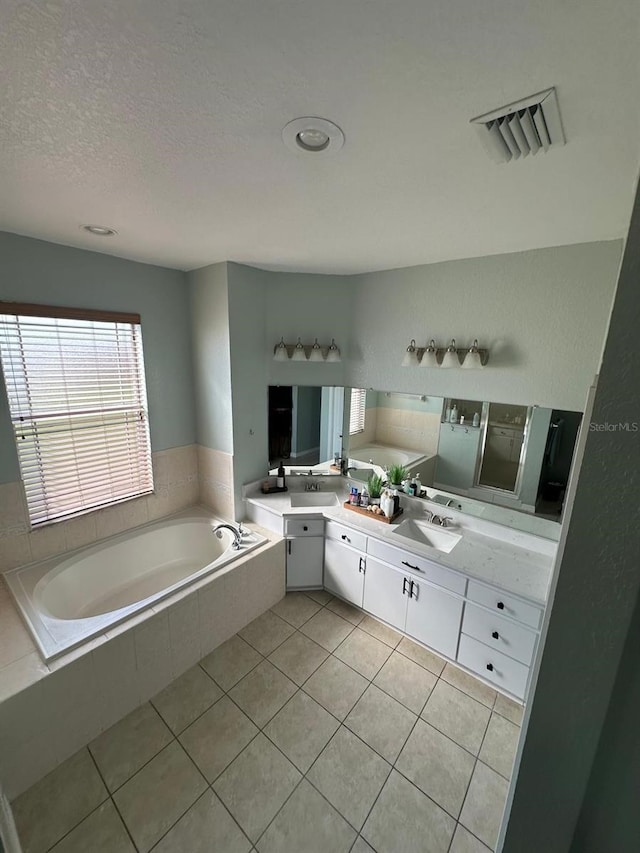 6003 Live Oak Dr, Winter Haven, FL 33880 - full bathroom featuring a garden tub, double vanity, tile patterned floors, and a textured ceiling
