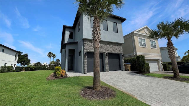 7551 Excitement Dr, Reunion, FL 34747 - view of front facade with stone siding, stucco siding, a garage, a front yard, and decorative driveway