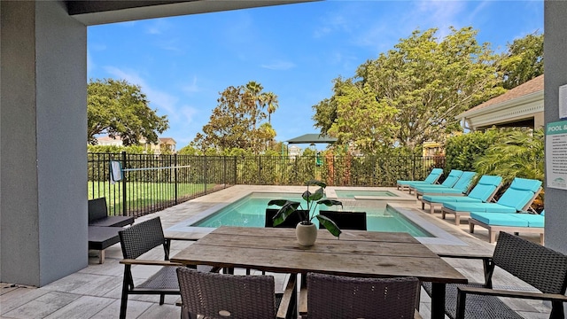 7551 Excitement Dr, Reunion, FL 34747 - view of patio with outdoor dining space and a pool with connected hot tub