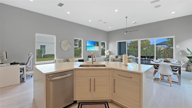 7551 Excitement Dr, Reunion, FL 34747 - kitchen featuring dishwasher, light wood finished floors, open floor plan, light brown cabinets, and light countertops