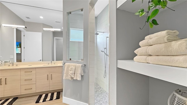 7551 Excitement Dr, Reunion, FL 34747 - bathroom with double vanity, tiled shower, wood finished floors, and recessed lighting