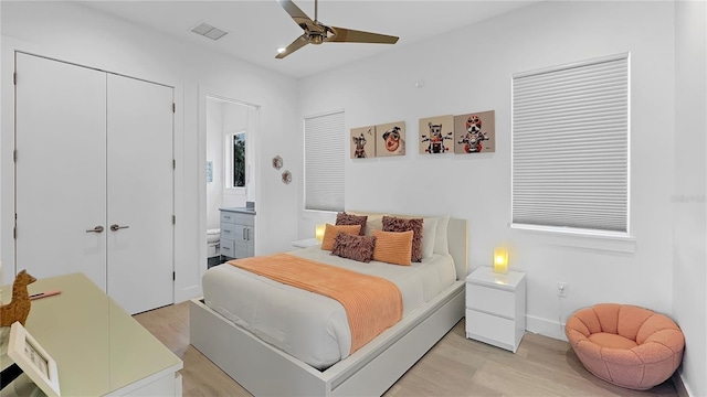 7551 Excitement Dr, Reunion, FL 34747 - bedroom with light wood-type flooring, a closet, ensuite bath, and a ceiling fan