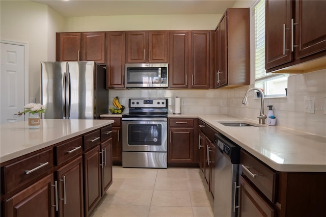 2712 Creekmore Ct, Kissimmee, FL 34746 - kitchen with stainless steel appliances, light countertops, tasteful backsplash, and light tile patterned floors