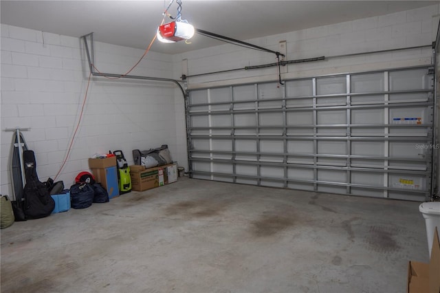 2712 Creekmore Ct, Kissimmee, FL 34746 - garage featuring a garage door opener and concrete block wall